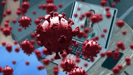 Animation of covid 19 cells over woman on laptop screen