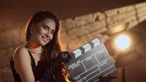 elegant woman with clapperboard