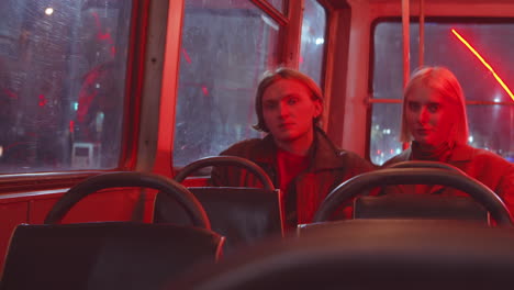 man and woman posing for camera in trolleybus