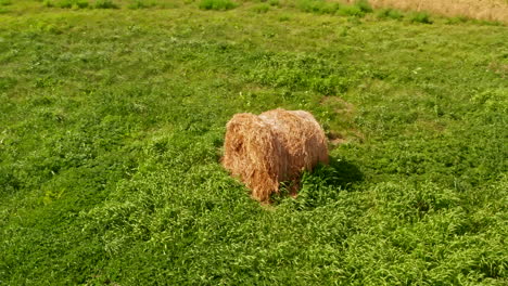 Rotational-movement-around-a-haystack-on-a-green-field