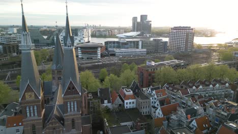 establishing drone shot over downtown amsterdam, modern buildings in background