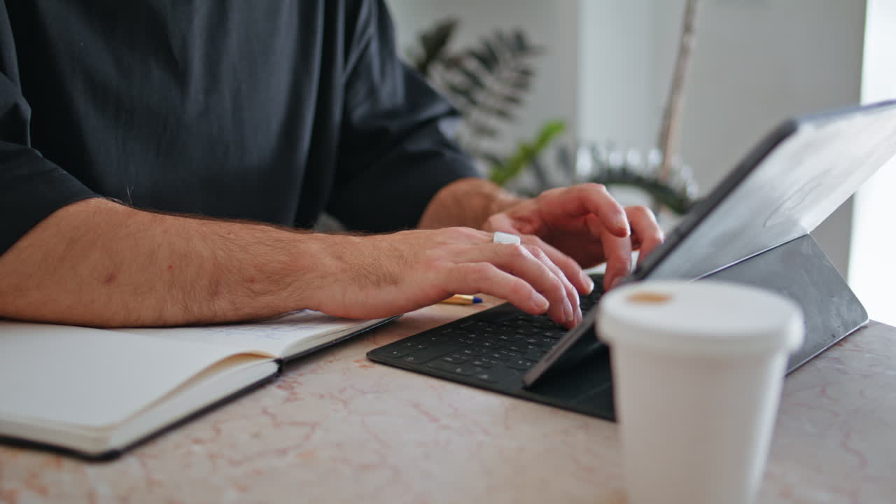 Closeup mature hands typing keyboard. Business owner making notes calculating