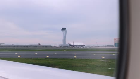 pov from passenger window of atc tower during departure at istanbul airport