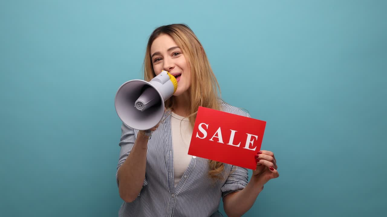 Young adult woman holding card with sale inscription and screaming in megaphone about discounts.