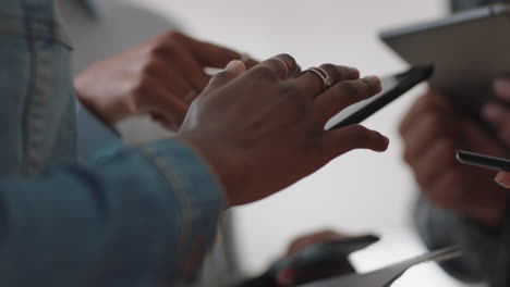 close up hands using digital tablet computers creative business people meeting sharing data brainstorming ideas for project enjoying teamwork in startup office