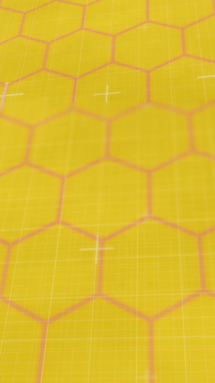Animation of red glowing lines on network of hexagons on yellow background