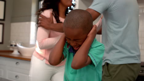parents arguing in front of son