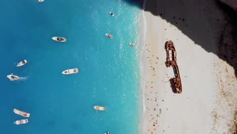 Aerial:-Top-down-view-of-the-Navagio-beach-with-the-famous-wrecked-ship-and-turquoise-water-in-Zante,-Greece