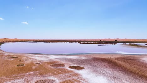 aerial establishing shot of wulan lake in the tengger desert in china