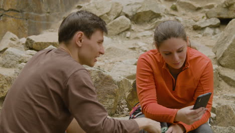 climbers sitting at the bottom of the cliff