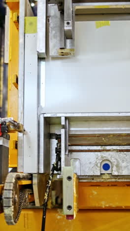 robotic equipment at work. modern factory indoors. upgraded technology inside the plant. close-up industrial process. vertical video