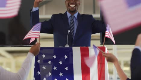 Victorious-male-speaker-and-audience-at-political-convention