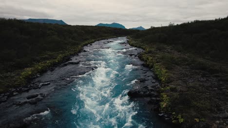 aerial clear blue waterfall river hlauptungufoss iceland, flying over icelandic landscape