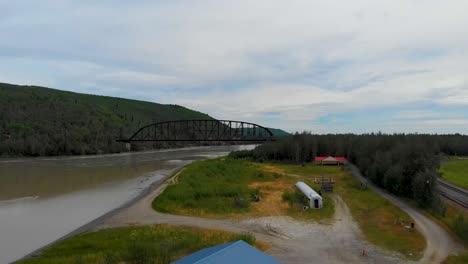 4K-Drone-Video-of-Mears-Memorial-Steel-Truss-Train-Bridge-over-the-Tanana-River-at-Nenana,-Alaska-during-Summer-Day