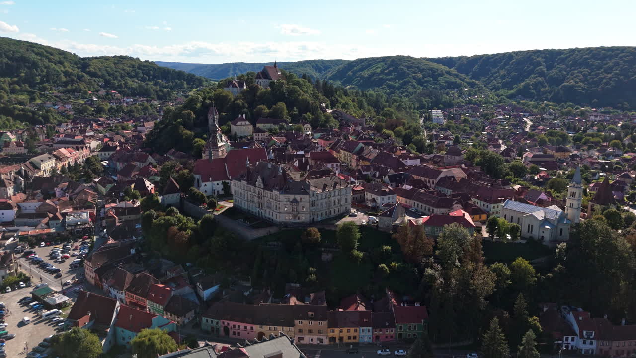 Scenic aerial view of Sighisoara's historic charm and lush landscape