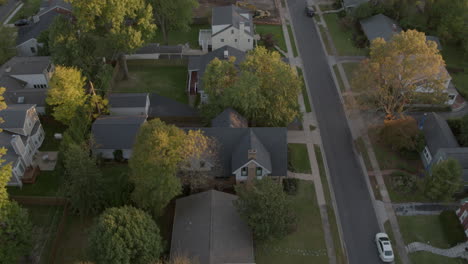 Aerial over neighborhood with small houses and new construction lot
