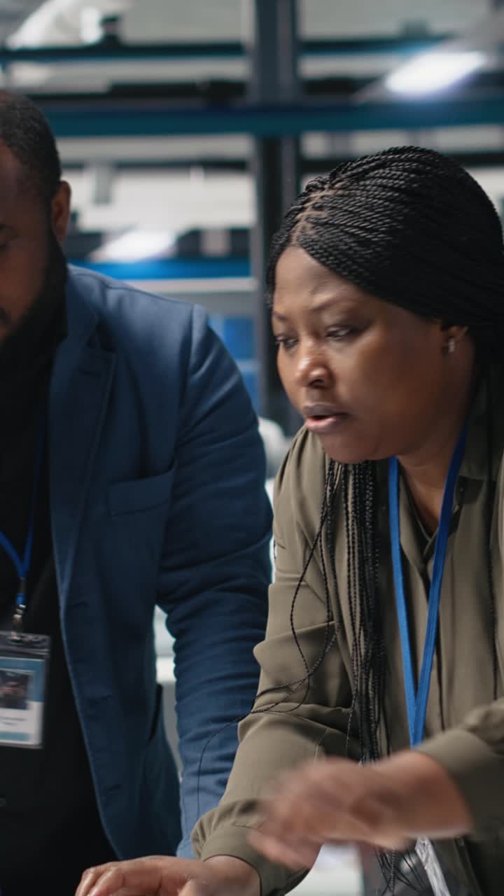 Vertical Video Team of african american consultants reviewing data and checklists