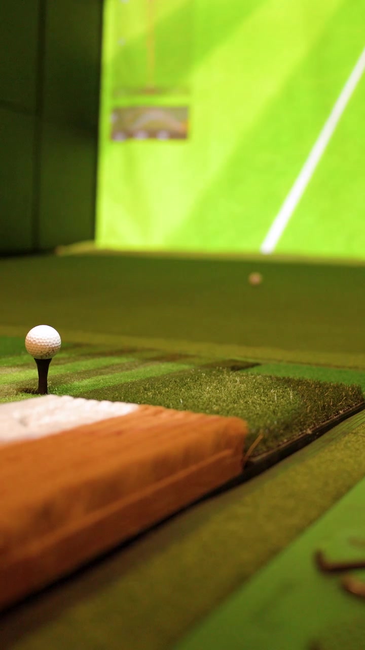 Primo piano statico di una pallina da golf su un tee all'interno di un simulatore di golf virtuale.