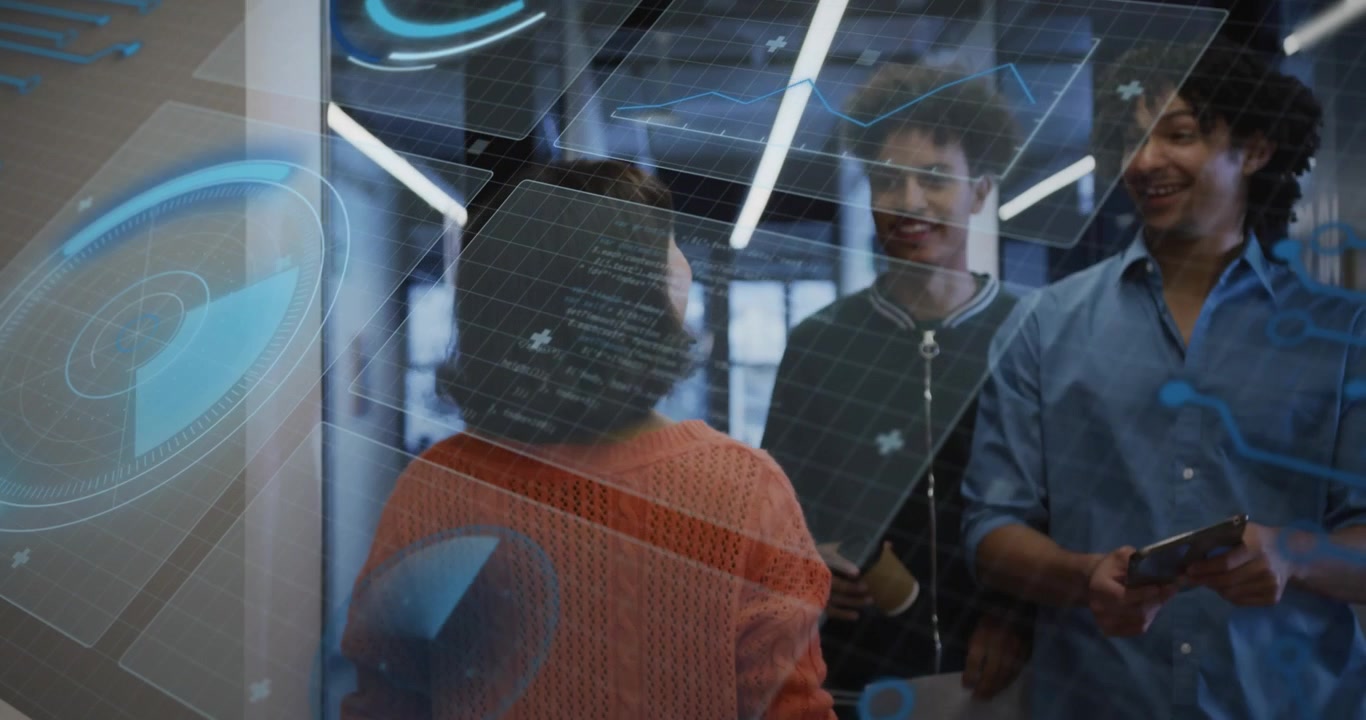 Woman walking hallway initiating holographic panels around technology team reviewing tablet charts