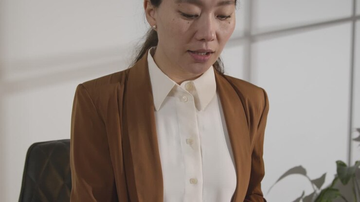 Businesswoman Interviewing Off Camera Candidate For Job In Office