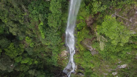aerial rises over wispy vine-like jungle waterfall, cascada el bejuco
