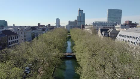 Aerial-view-above-famous-shopping-street,-Köningsallee-with-Dusseldorf-Skyline