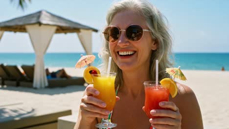 a joyful moment: woman enjoying tropical cocktails on a sunny beach under clear sky with beautiful ocean view