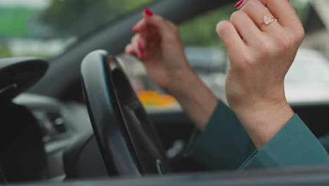 hands of desperate female driver hitting steering wheel