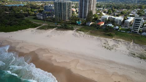 foamy waves in the shoreline of palm beach in queensland, australia - drone shot