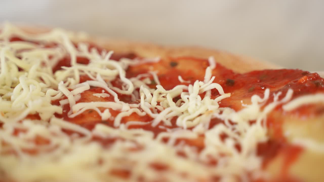 Adding Grated Cheese to Pizza Topping, Extreme Close up with Copy Space