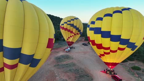Colorful-Hot-Air-Balloons-Getting-Ready-For-Flight-In-Sedona,-Arizona,USA---aerial-drone-shot