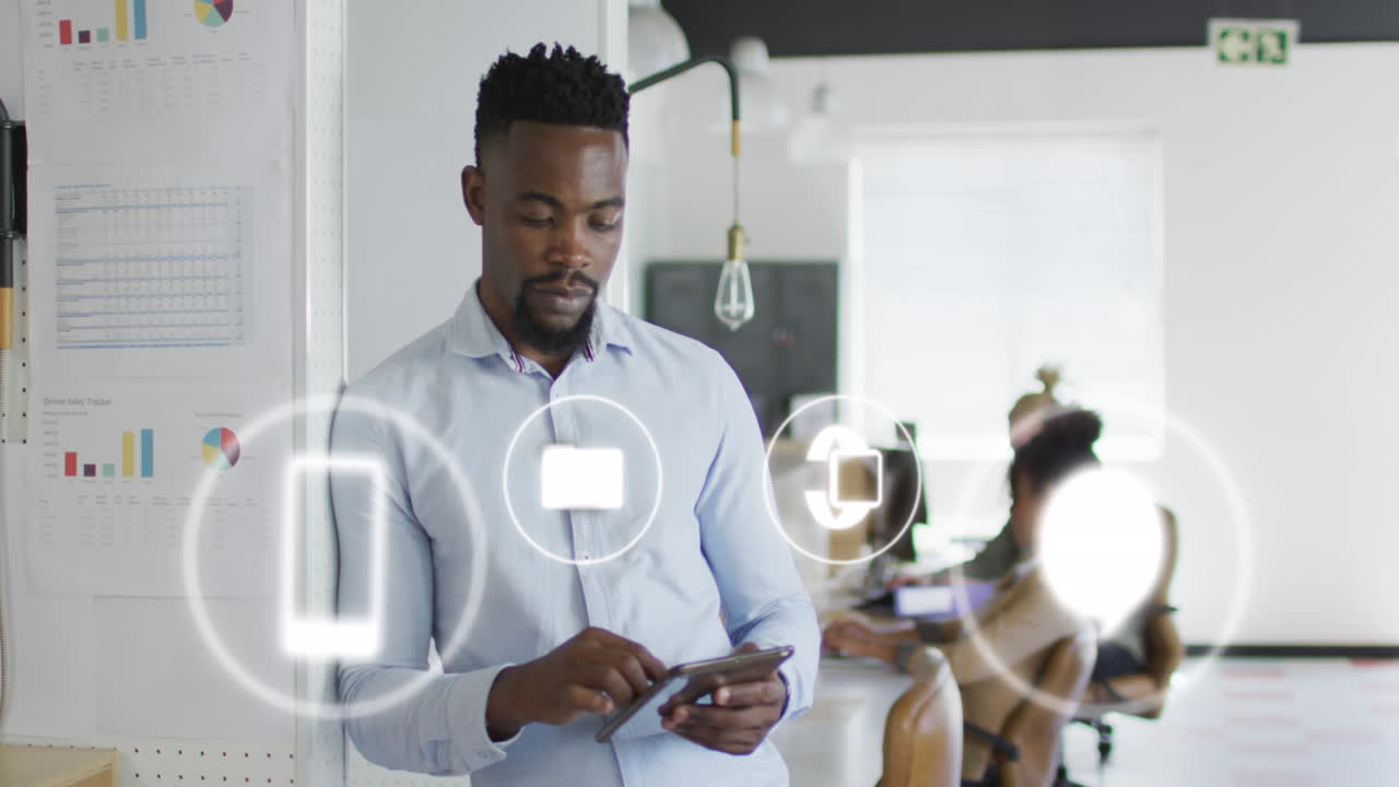 Animation of icons and data processing over african american businessman in office