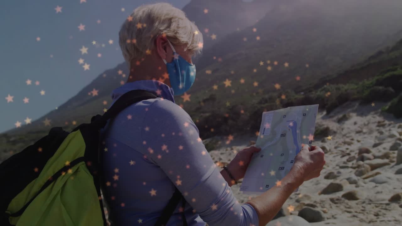 Travel hiker arriving on mountain beach unfolding map while matching route as star lights drifting