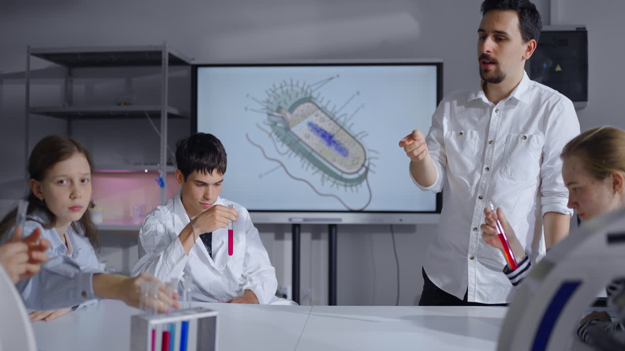 교사 가 학생 들 에게 박테리아 에 관한 과학 수업 을 설명 하고 있다