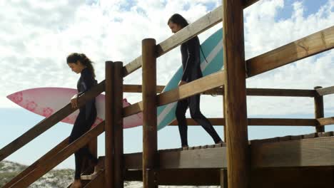 couple moving downstairs from wooden walkway 4k