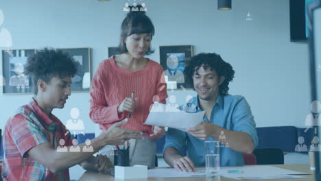 animation of profile icons over diverse coworkers sharing ideas in office