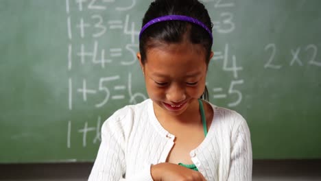 Schoolgirl-using-digital-tablet-in-classroom-at-school