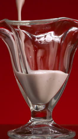 pouring yogurt into a glass dish