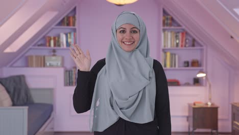 happy muslim woman saying hi