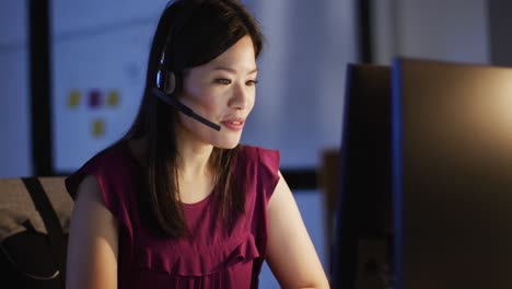 video of happy asian female consultant working late in office