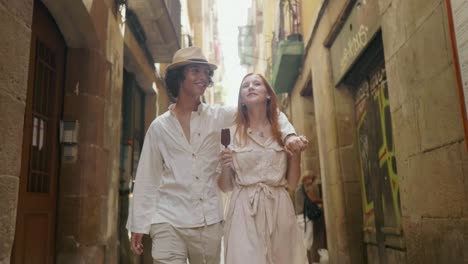 cute man kissing woman nose outdoor. young couple relaxing on old city street