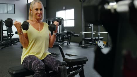 Senior-woman-exercising-with-dumbbell-in-fitness-studio-4k