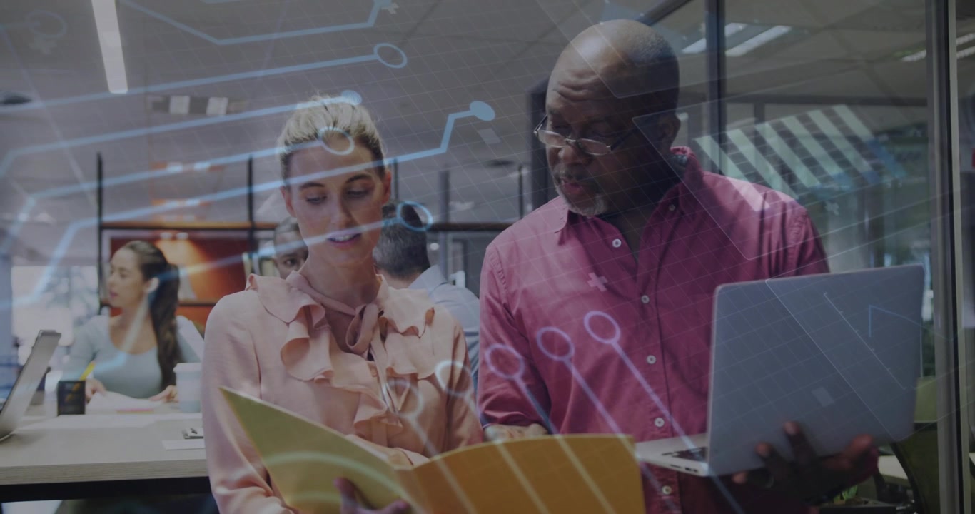 Woman flipping folder revealing chart, man tapping laptop under circuit overlay in business review