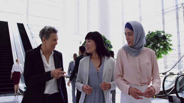 Businesswomen interacting with each other in the lobby at office 4k