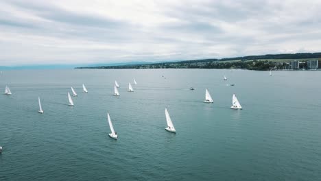 a drone pans left across the annual sailboat regatta held on lake constance