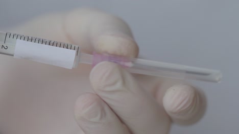 hand removes needle from syringe - close up - copy space