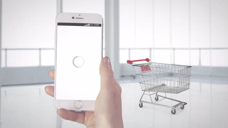 animación de un teléfono inteligente en la mano usando una aplicación de compras, sobre cajas que aterrizan en el carrito de compras