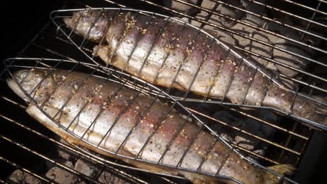 tasty whole fishes placed on barbecue grill