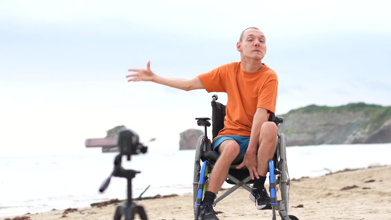 Man in Wheelchair Vlogging on Beach