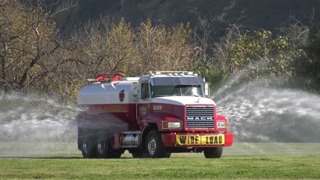 Truck-spraying-water-on-open-field